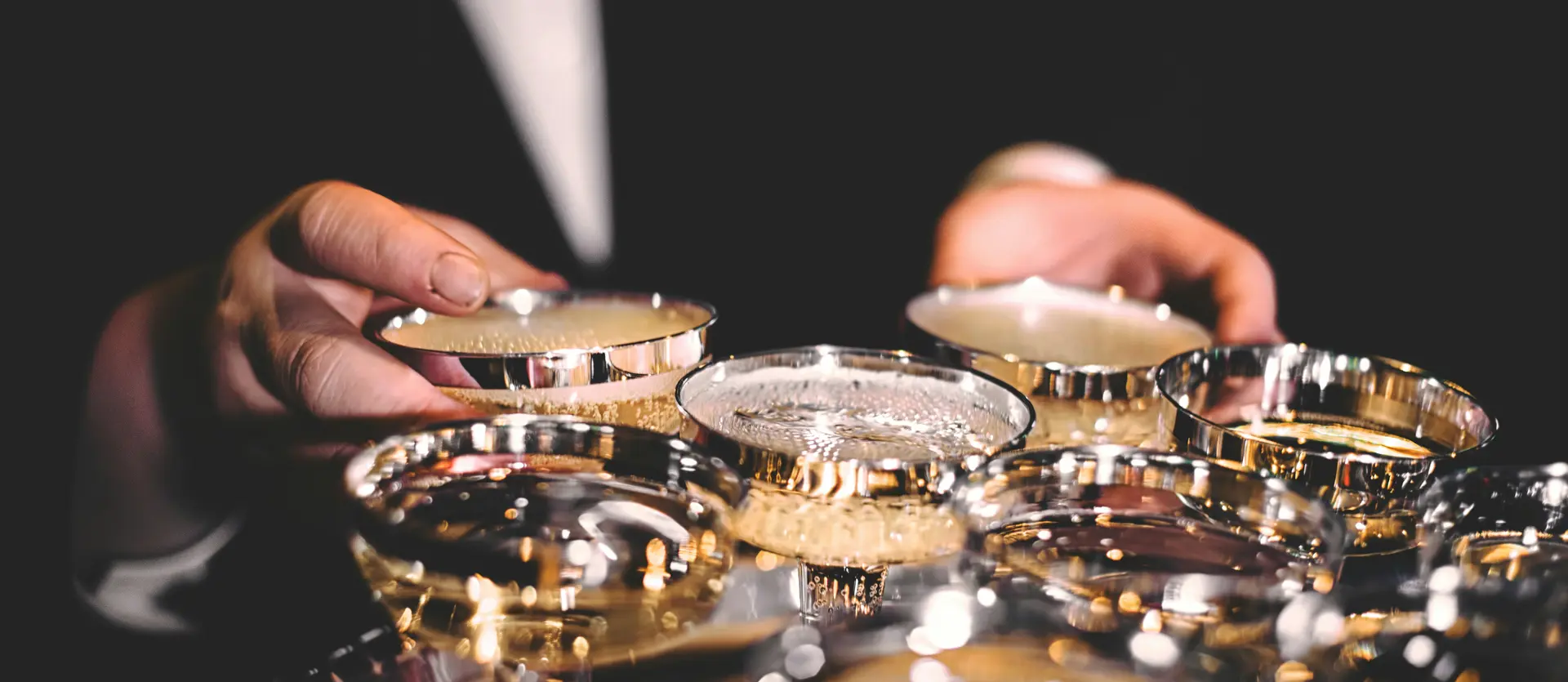 Events on the Grossglockner High Alpine Road Waiter holding tray with multiple filled champagne glasses