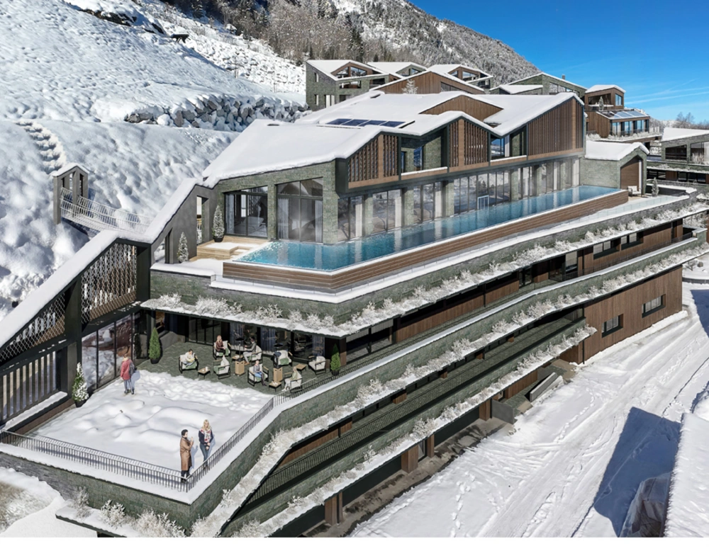 Modern hotel with outdoor pool and terrace in snowy mountain area