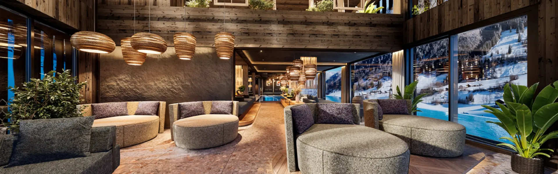 Gemütliche Lounge mit modernen Sesseln und Panoramafenstern mit Bergblick