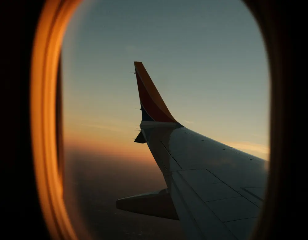 Directions to the Grossglockner High Alpine Road and glockna View of airplane wing and sunset sky through airplane window
