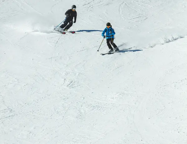 glockna – the most legendary accommodation near Salzburg? Two skiers skiing side by side on a snowy slope