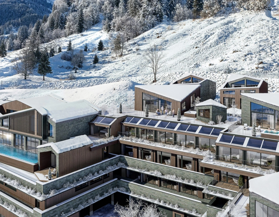 Modern hotel with outdoor pool in snowy mountain landscape