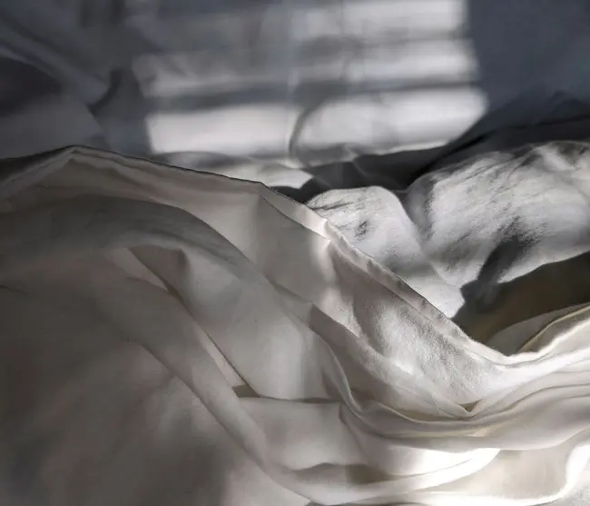 glockna in the press White crumpled bedsheet with sunlight and shadows