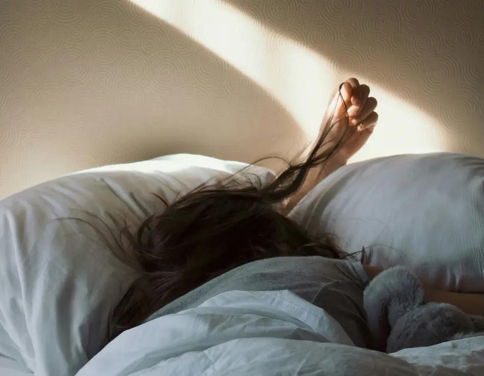 The business hotel in the Salzburg region Person sleeping in bed with sunlight casting on the wall