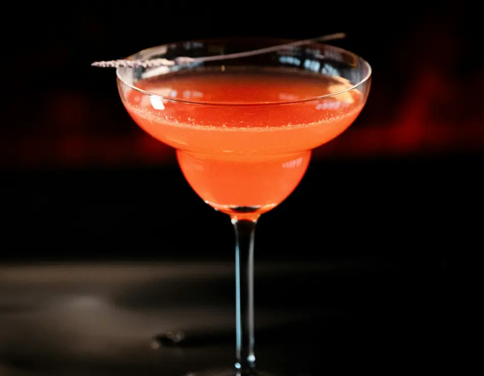 glockna bar – drinks & sundowners on the Grossglockner Road Orange cocktail in a coupe glass with a garnish on top